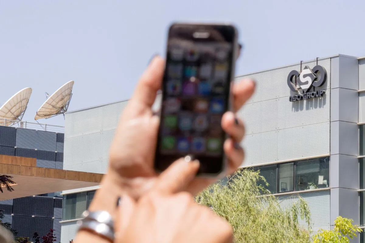 A woman uses her iPhone, in a file photo. (Jack Guez/AFP via Getty Images)