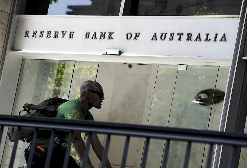 A bike courier rides past the entrance to the Reserve Bank of Australia (RBA) in Sydney's central business district on April 2, 2013. (Greg Wood/AFP via Getty Images)