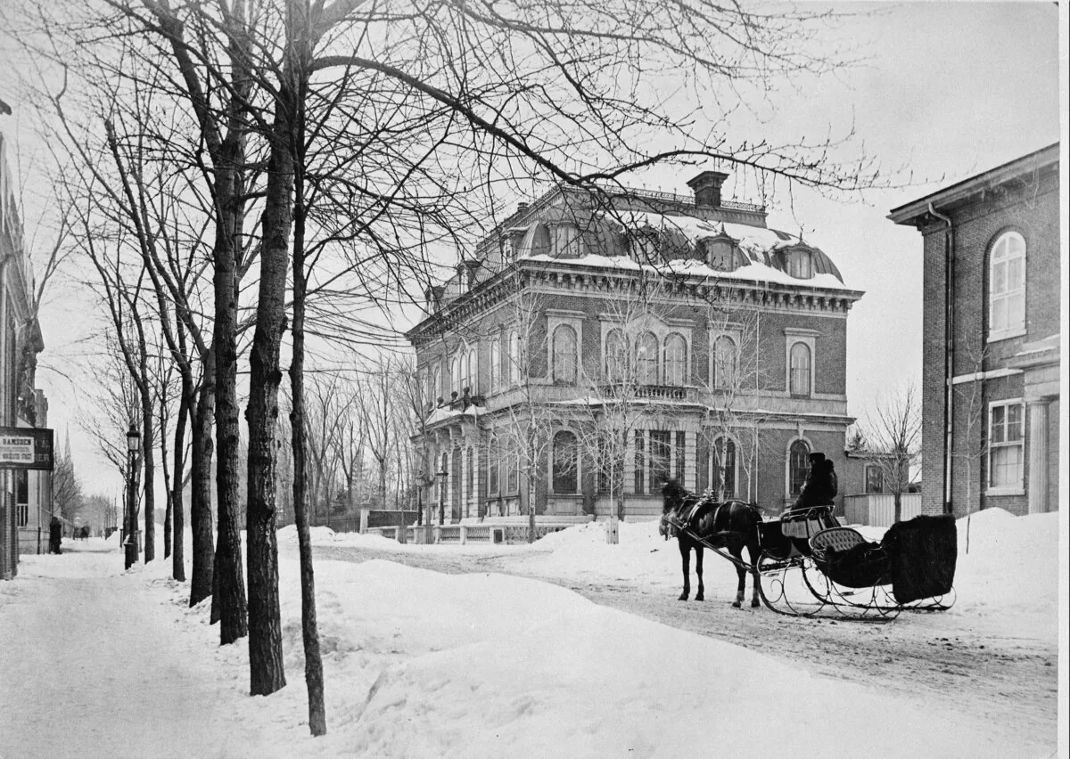A horse-drawn sleigh waits near St. James's Club on Dorchester Street in Montreal, circa 1875. (CP Photo)
