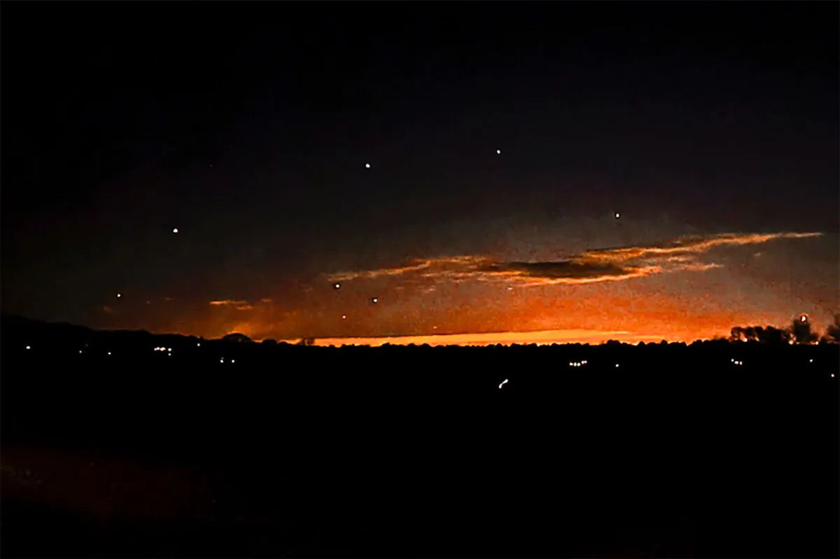 The evening sky and points of light near in Lebanon Township, N.J., on Dec. 5, 2024. (Trisha Bushey via AP)