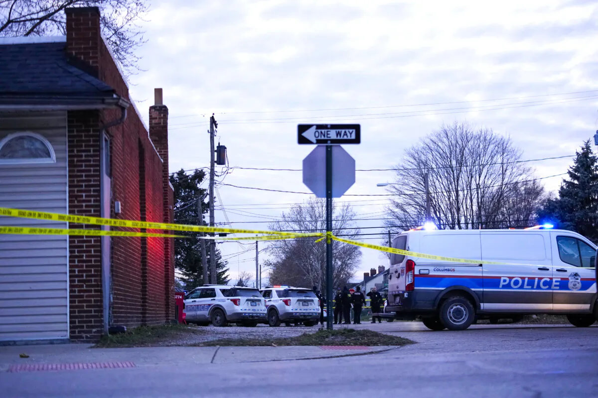 Columbus Police Department investigate the scene of a homicide on South Ohio Avenue as seen from the intersection of East Mithoff Street and South Ohio Avenue on in Columbus, Ohio, on Dec. 14, 2024. (Samantha Madar/The Columbus Dispatch via AP)