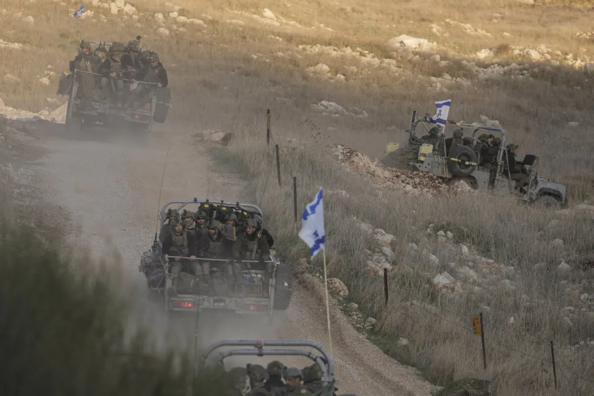 Israeli soldiers cross the security fence moving toward the so-called Alpha Line that separates the Israeli-controlled Golan Heights from Syria, in the town of Majdal Shams, on Dec. 15, 2024. (Matias Delacroix/AP)