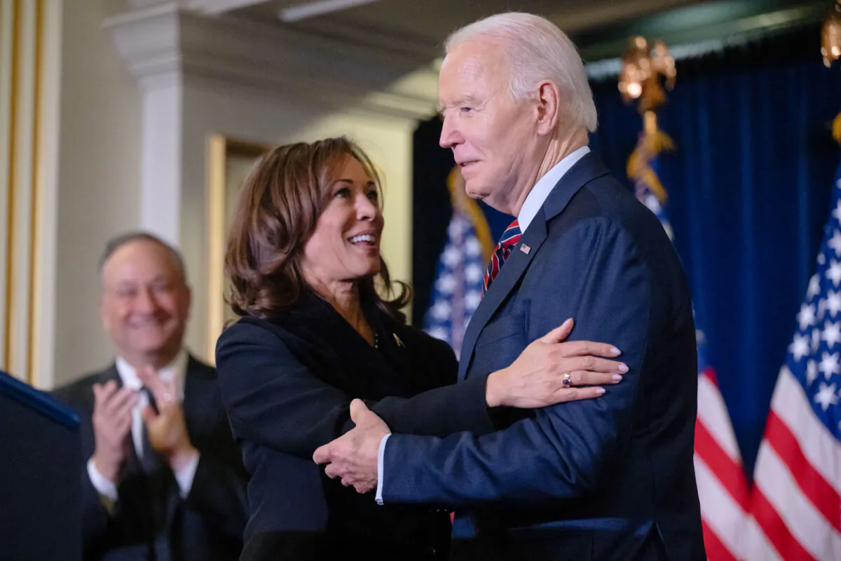 Vice President Kamala Harris embraces President Joe Biden prior to speaking during the Democratic National Committee's Holiday Reception in Washington on Dec. 15, 2024. (Saul Loeb/AFP via Getty Images)