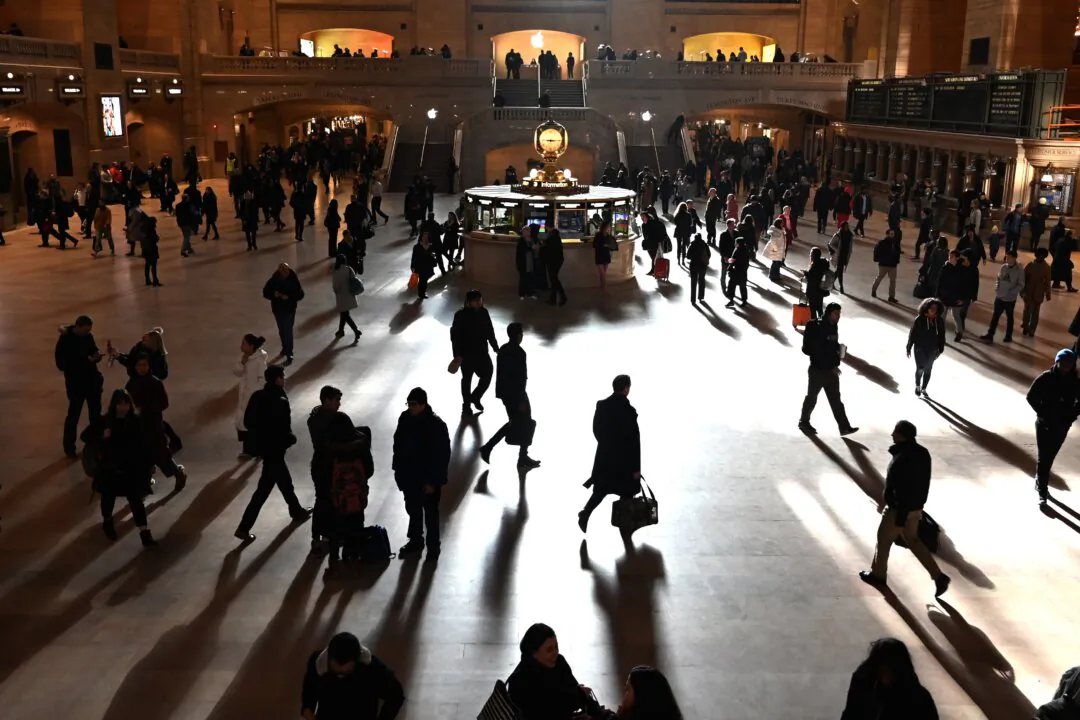 Commuters walk through the bright morning sunlight coming from windows in Grand Central Terminal in New York City, on March 11, 2019. (Timothy A. Clary/AFP via Getty Images)