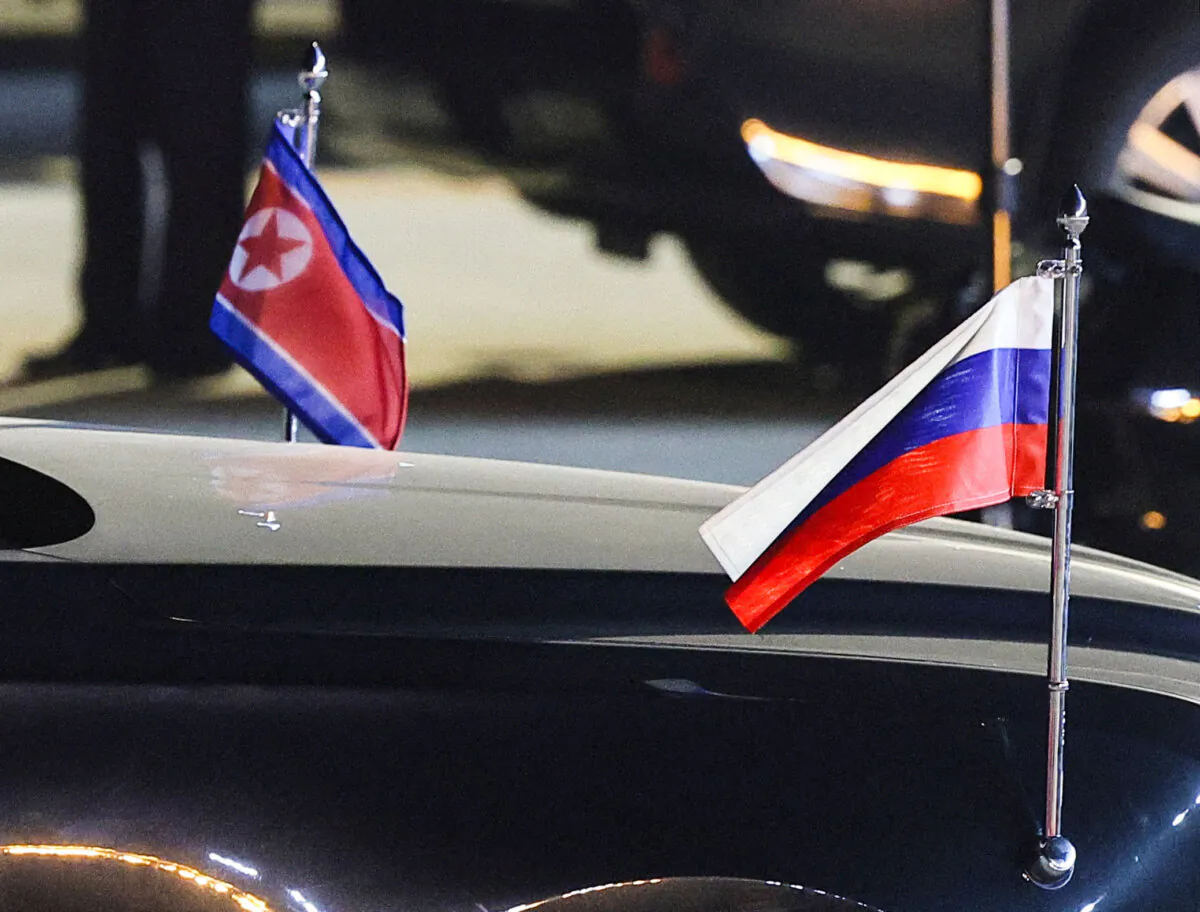 Flags of Russia and North Korea attached to a car during a ceremony welcoming Russian President Vladimir Putin at an airport in Pyongyang, North Korea, on June 19, 2024. (Sputnik/Vladimir Smirnov/Reuters)