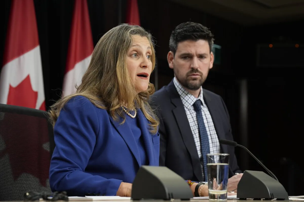 Minister of Housing, Infrastructure and Communities Sean Fraser listens to Deputy Prime Minister and Finance Minister Chrystia Freeland speak during a news conference, on Dec. 10, 2024. (The Canadian Press/Adrian Wyld)