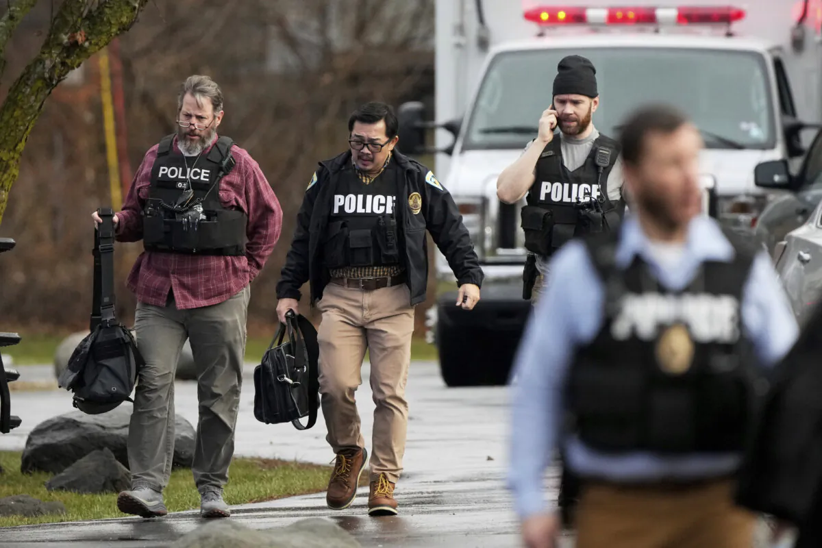 Police walk outside the Abundant Life Christian School following a shooting in Madison, Wis., on Dec. 16, 2024. (Morry Gash/AP Photo)