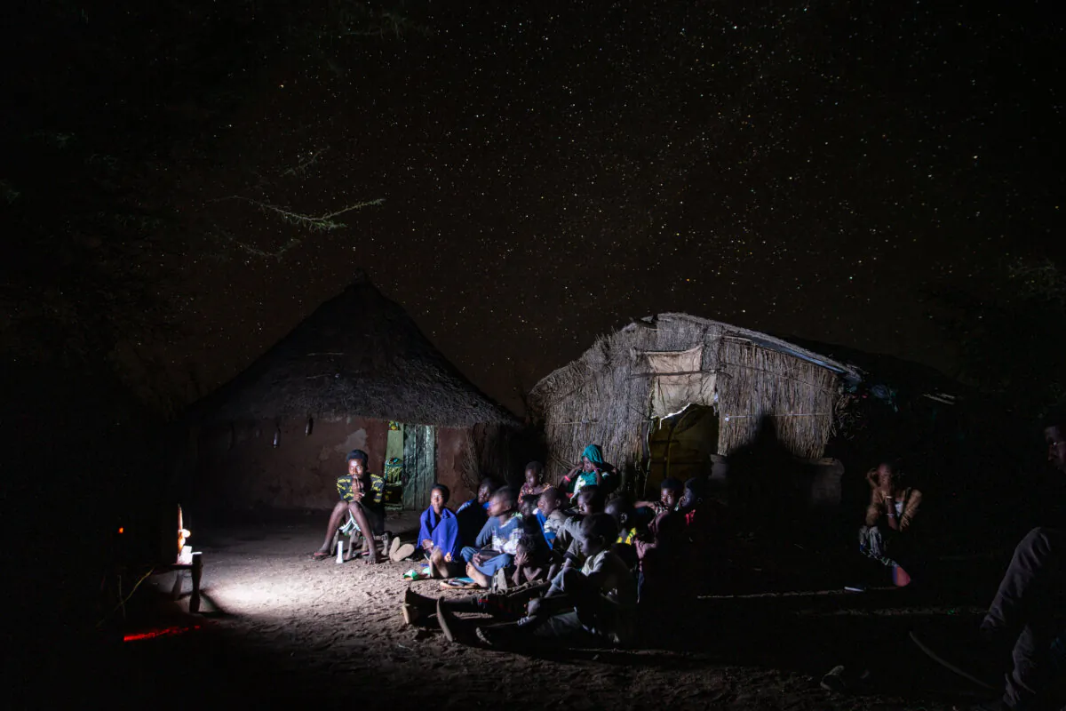 People watch the television during the only two hours of electricity per day in the Sudanese village of Um Rakuba, on Jan. 7, 2021. (Abdulmonam Eassa/Getty Images)