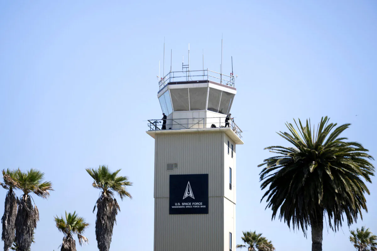 Members of a Secret Service counter sniper team watch from a control tower as President Joe Biden arrives to board Air Force One at Vandenberg Space Force Base in California, on Aug. 25, 2024. (Photo by Brendan Smialowski / AFP)