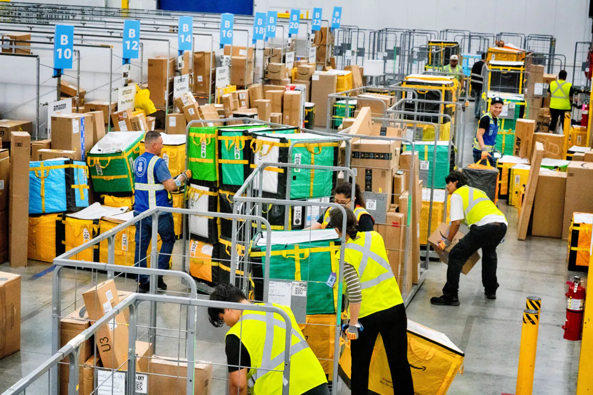 Employees load packages at an Amazon delivery station in South Gate, Calif., on July 16, 2024. (Richard Vogel/AP Photo)