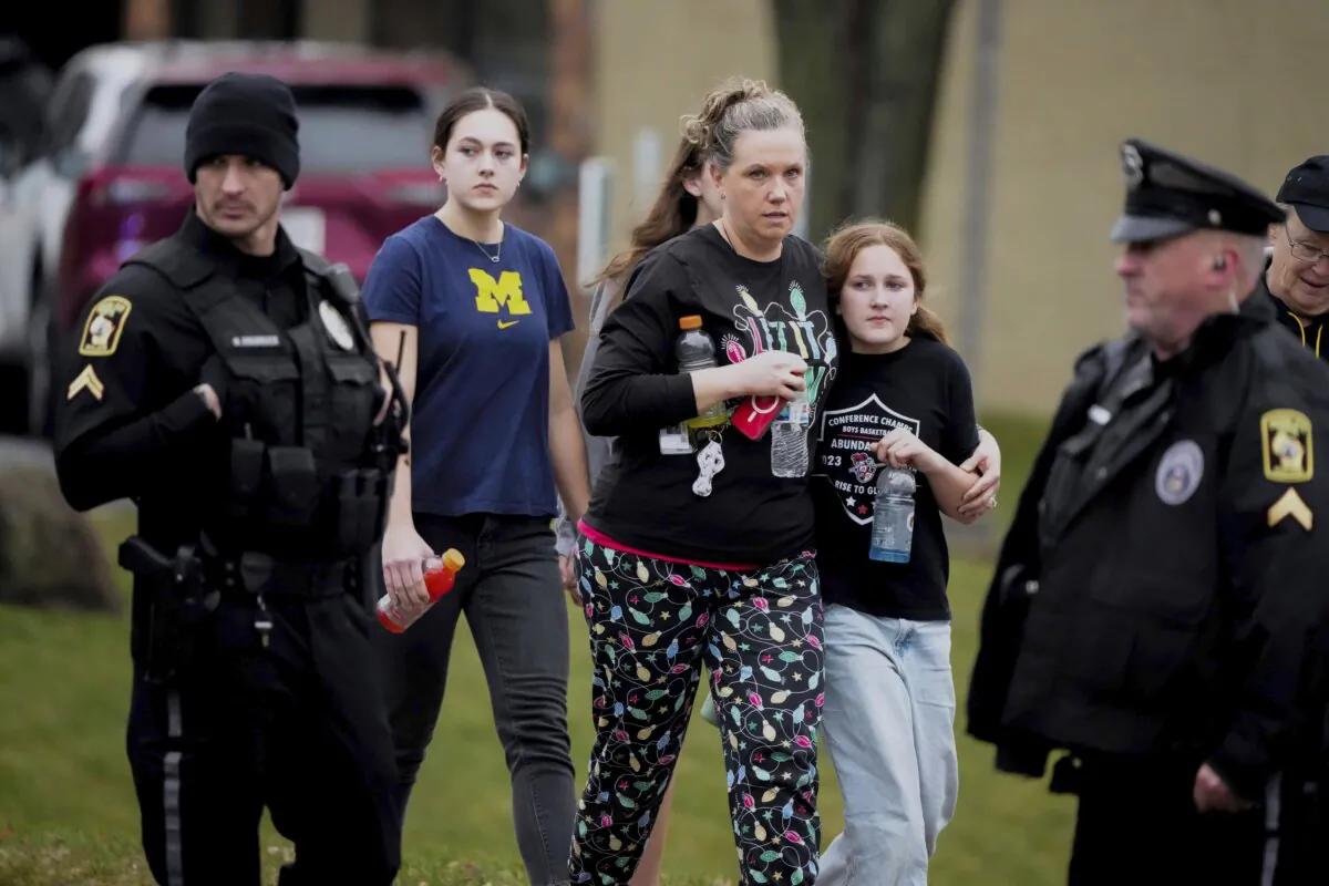 A family leave the shelter after multiple injuries were reported following a shooting at the Abundant Life Christian School in Madison, Wis., on Dec. 16, 2024. (Morry Gash/AP Photo)