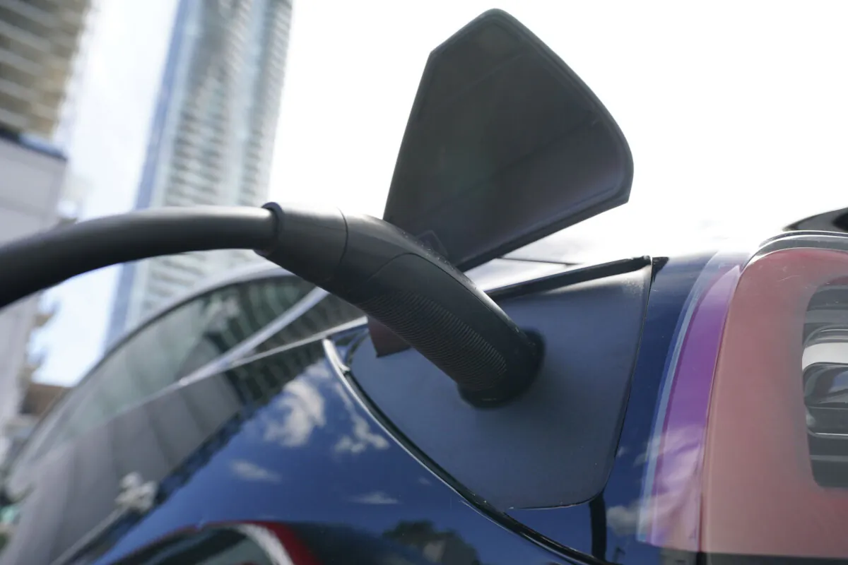 An electric vehicle is charged in Ottawa on July 13, 2022. (The Canadian Press/Sean Kilpatrick) 