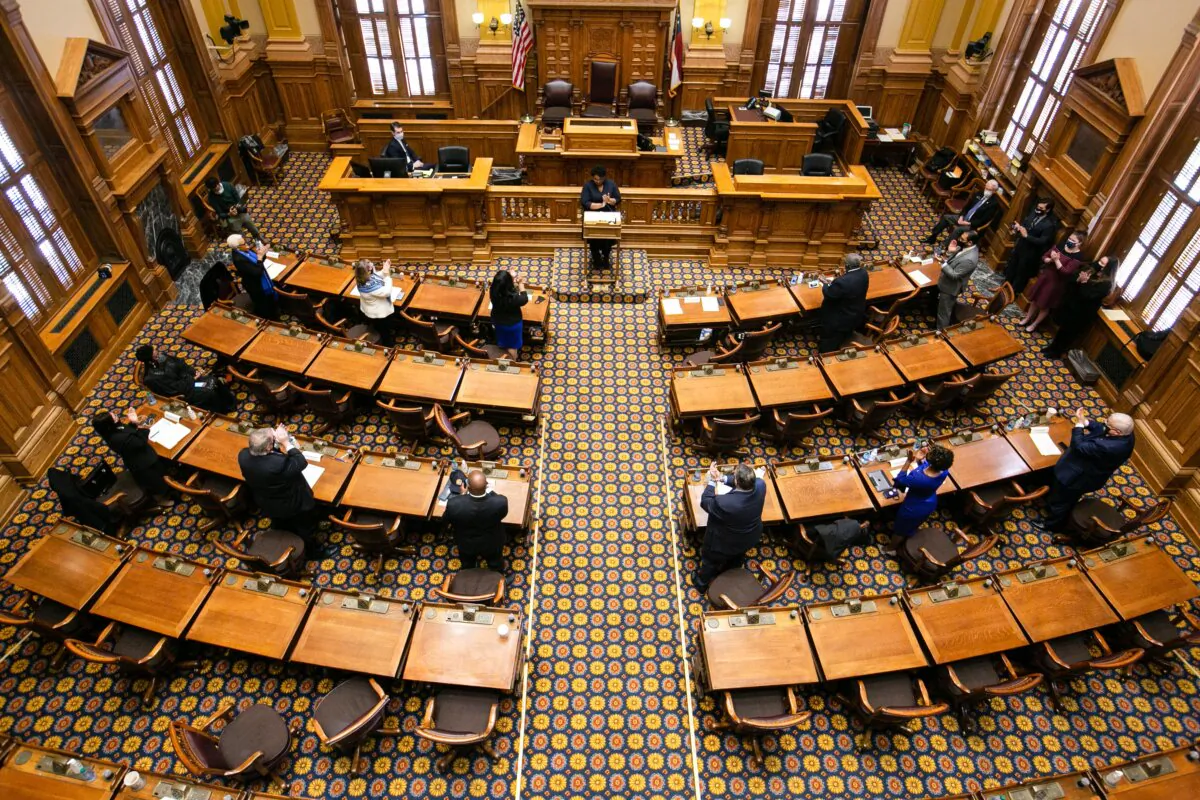 Georgia Electors stand and clap after casting their Electoral College votes at the Georgia State Capitol in Atlanta on Dec. 14, 2020. (Jessica McGowan/Getty Images)