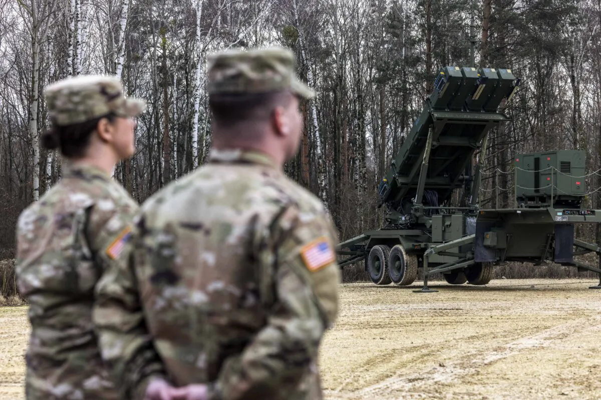 US soldiers stand near to surface-to-air missile launchers of the Patriot system of 37th Air Defense Missile Squadron from the 3rd Warsaw Air Defense Missile Brigade in Sochaczew, Poland, on Dec. 18, 2024. (Wojtek Radwanski/AFP via Getty Images)