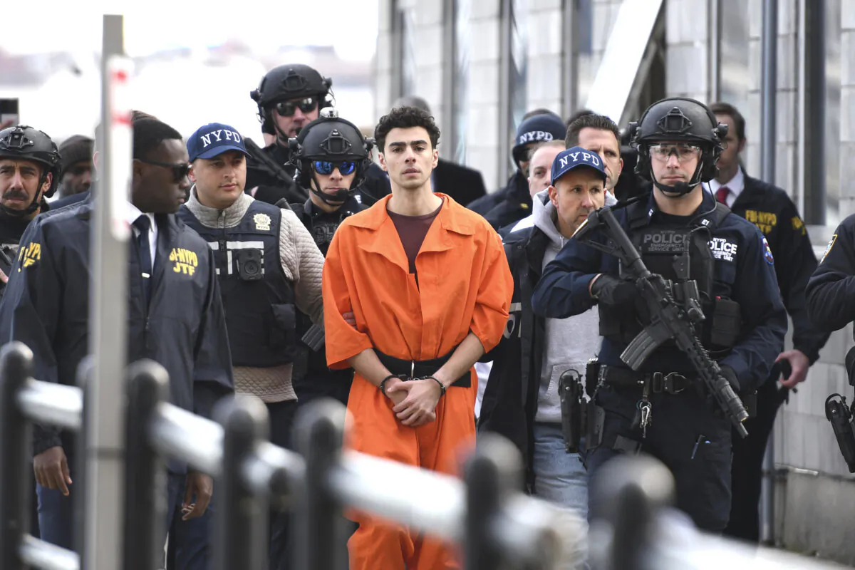Luigi Mangione, a suspect in the fatal shooting of UnitedHealthcare CEO Brian Thompson, is escorted by police in New York on Dec. 19, 2024. (Pamela Smith/AP Photo)