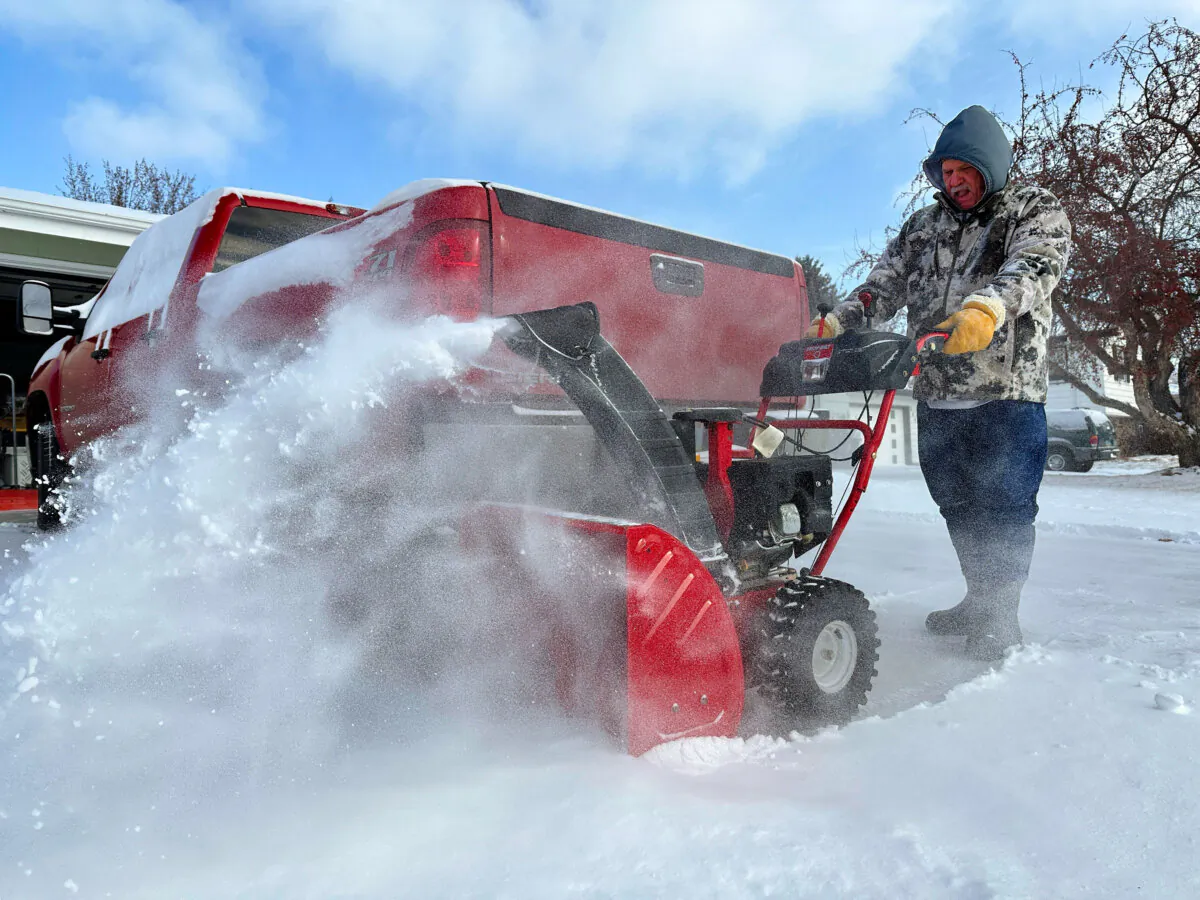 Jim Thom clears his driveway of snow with a snowblower in Bismarck, N.D., on Dec. 19, 2024. (Jack Dura/AP Photo)