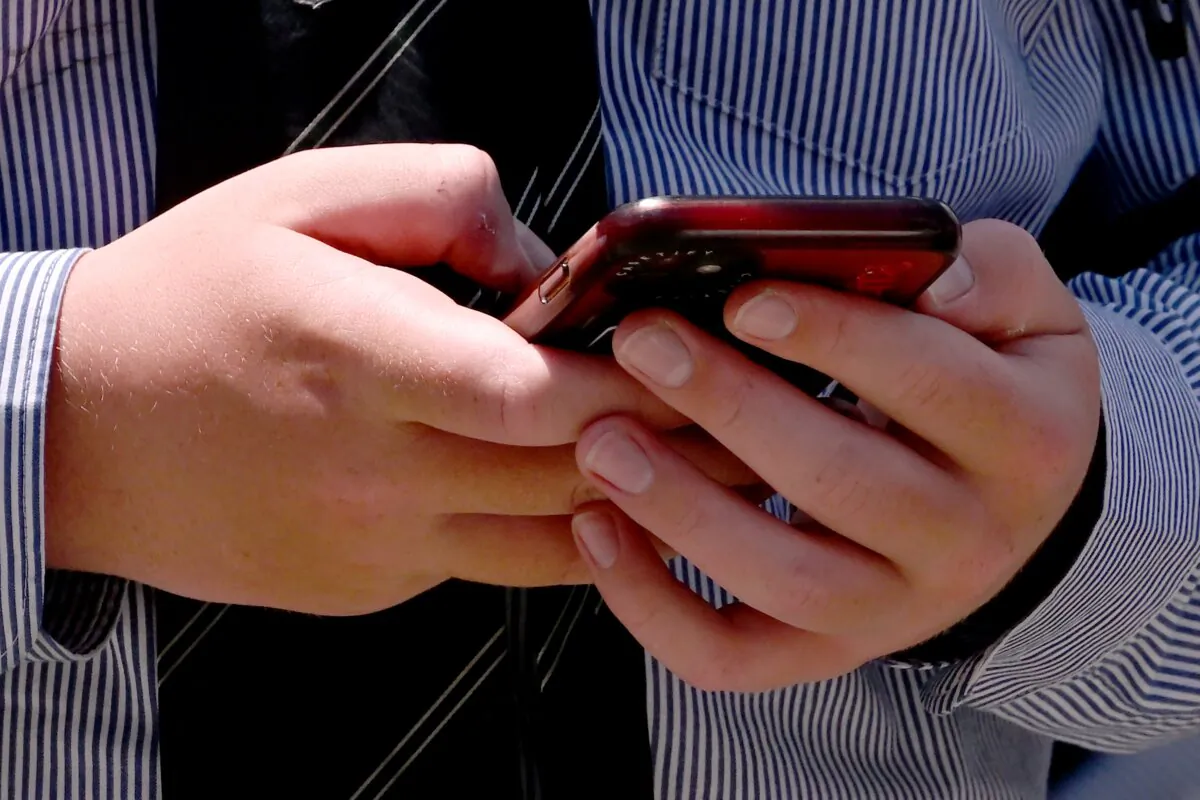 A schoolboy looks at his phone in Melbourne, Australia on Nov. 27, 2024. (William West/AFP via Getty Images)