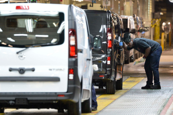 An employee inspects a car at the Vauxhall vehicle production plant in Luton, Bedfordshire, England, on Feb. 18, 2015. (Toby Melville/PA Wire)