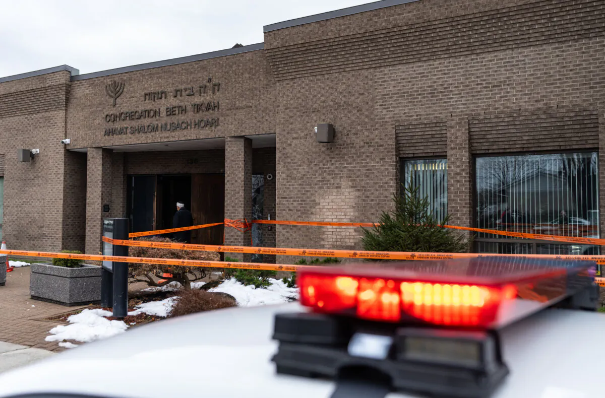 A police car sits outside Congregation Beth Tikvah, as police investigate alleged arson at the synagogue in the suburb of Dollard-des-Ormeaux in Montreal on Dec.18, 2024. (The Canadian Press/Christinne Muschi)