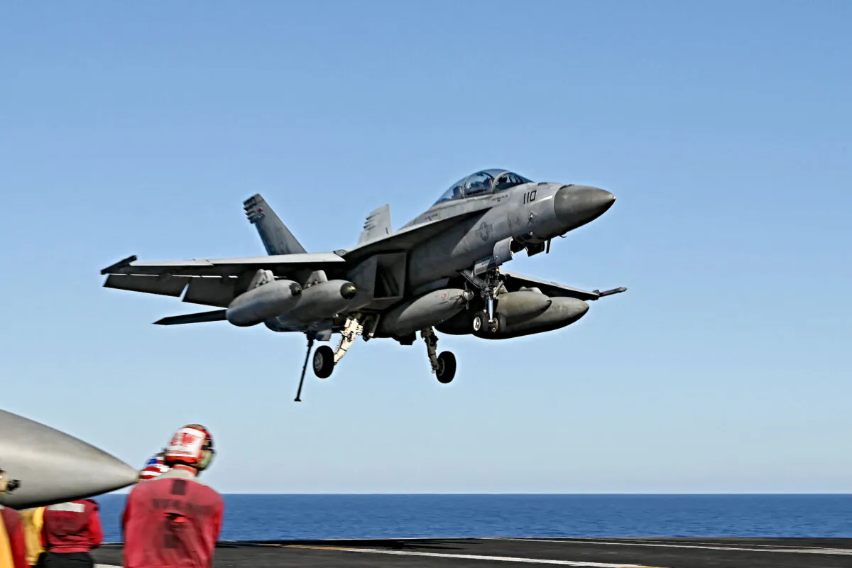 An F/A-18 Hornet fighter jet landing on the deck of the US Nimitz-class nuclear-powered aircraft carrier USS Harry S. Truman, during a NATO vigilance activity Neptune Shield 2022 (NESH22) on eastern Mediterranean Sea on May 23, 2022. (Andreas Solaro/AFP via Getty Images)