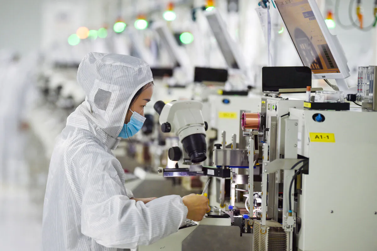 A worker producing semiconductor chips at a workshop in Suqian, China, on Feb. 28, 2023. (STR/AFP via Getty Images)
