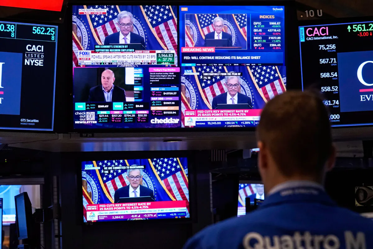 Comments by Federal Reserve Chair Jerome Powell appear on a bank of screens on the floor of the New York Stock Exchange on Nov. 7, 2024. (Richard Drew/AP Photo)