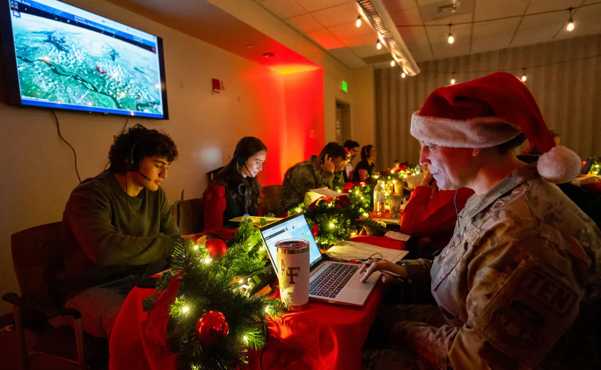 Air Force Col. Amy Glisson and other volunteers answer phone calls from around the world at the NORAD Tracks Santa center at Peterson Space Force Base in Colorado Springs, Colo., on Dec. 24, 2024. (Christian Murdock/The Gazette via AP)