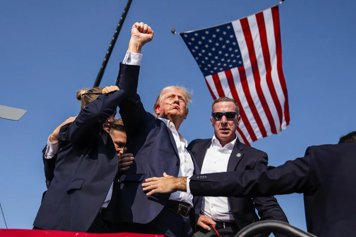 Republican presidential candidate and former President Donald Trump raises his fist shortly after the assassination attempt at a campaign rally, in Butler, Pa., on July 13, 2024. (Evan Vucci/AP Photo)