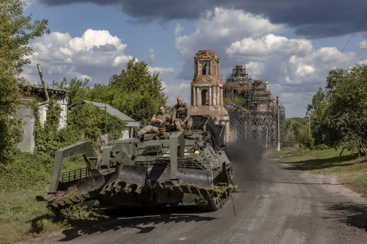 Ukrainian servicemen operate an armored military vehicle on a road near the border with Russia, in the Sumy region of Ukraine, on Aug. 14, 2024. (Roman Pilipey/AFP via Getty Images)