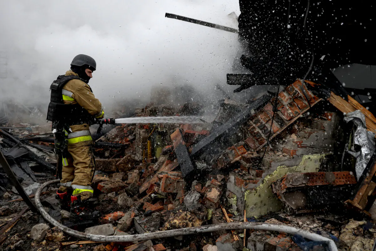 A firefighter works at the site of residential buildings hit by a Russian drone strike, in Kharkiv, Ukraine, on Dec. 25, 2024. (Sofiia Gatilova/Reuters)
