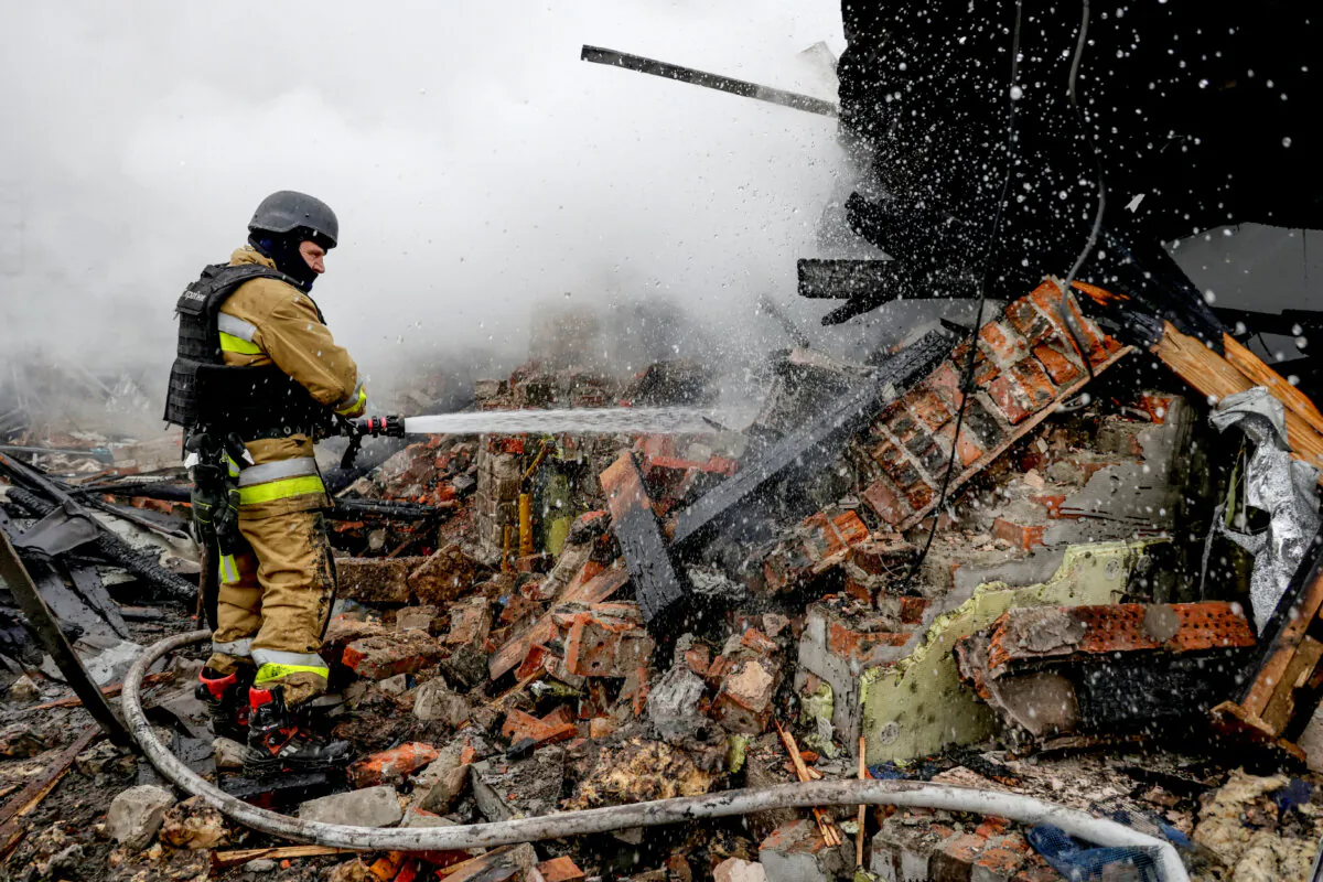 A firefighter works at the site of residential buildings hit by a Russian drone strike, in Kharkiv, Ukraine, on Dec. 25, 2024. (Sofiia Gatilova/Reuters)