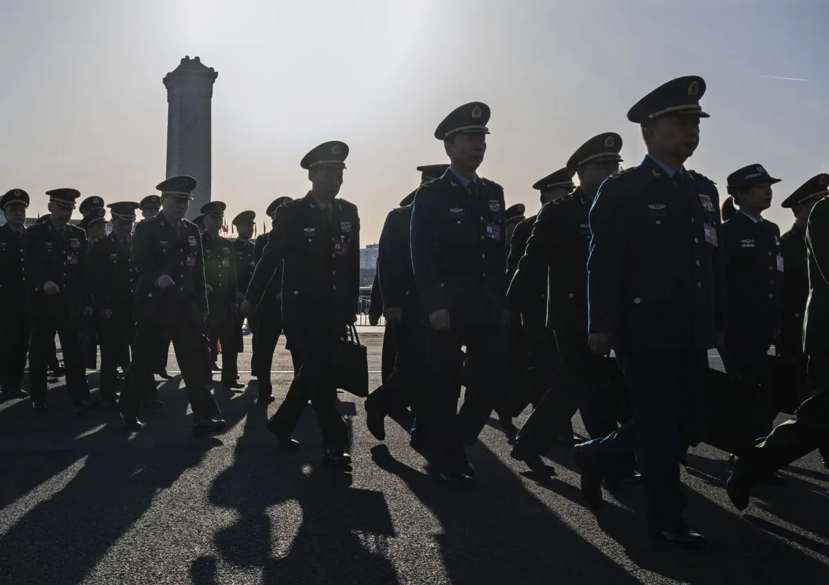 Chinese military delegates arrive at the second plenary session of the National People's Congress in Beijing on March 8, 2024. (Kevin Frayer/Getty Images)