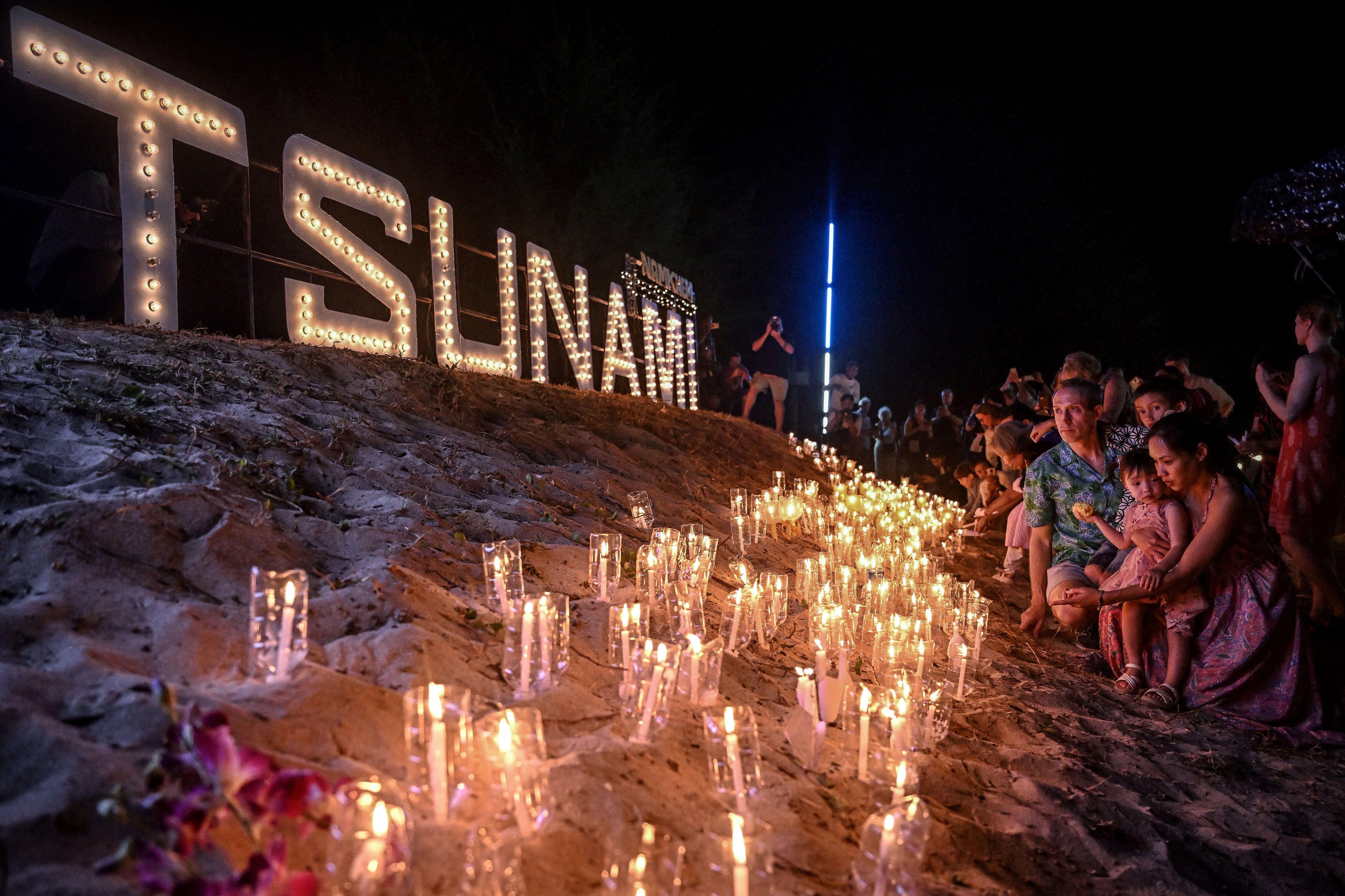 Day in Photos: Tsunami Memorial, Plane Crash in Kazakhstan, and Boxing Day Bath