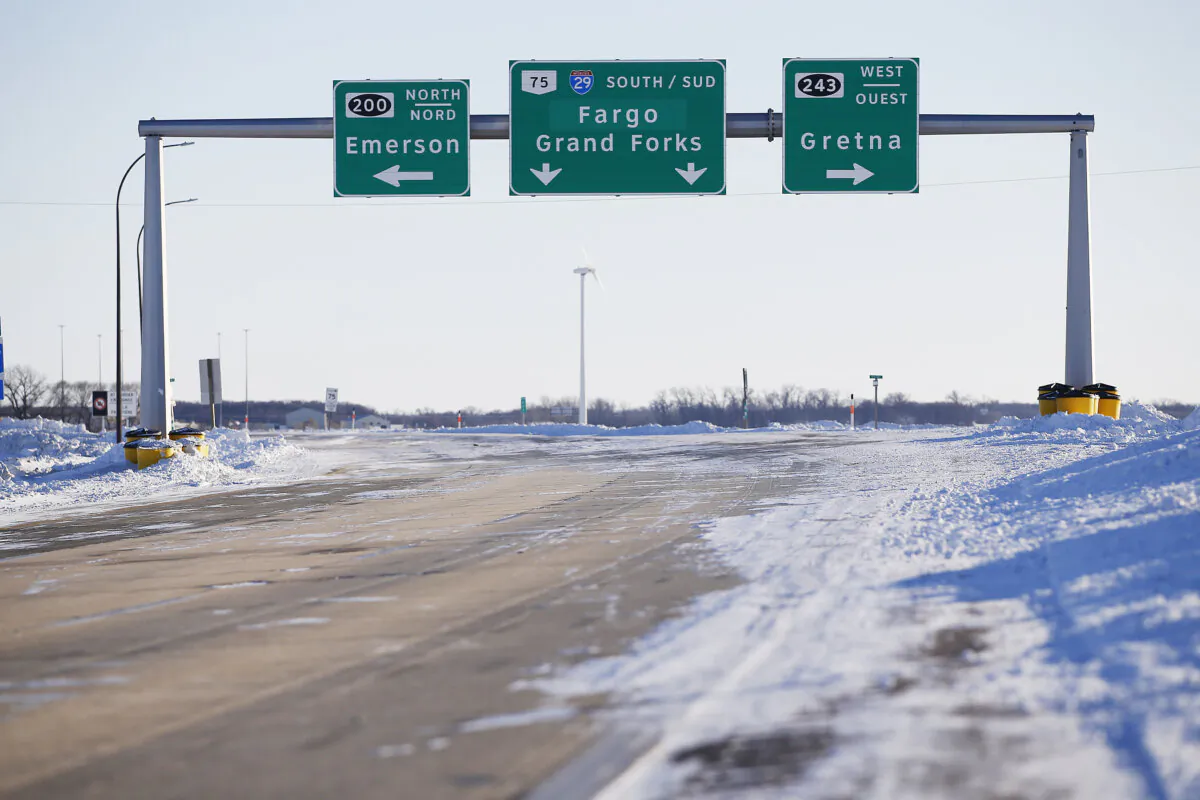 Road signage is posted just outside of Emerson, Man., on Jan. 20, 2022. (The Canadian Press/John Woods)