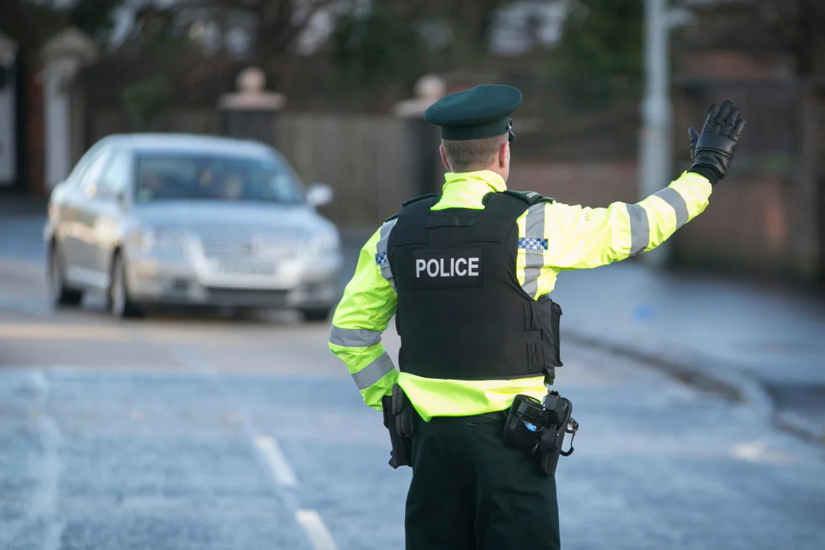 A PSNI road policing officer flags down oncoming drivers during a random drink driving checkpoint in Belfast, Northern Ireland, in this file photo from Dec. 21, 2016. (Liam McBurney/PA Wire)