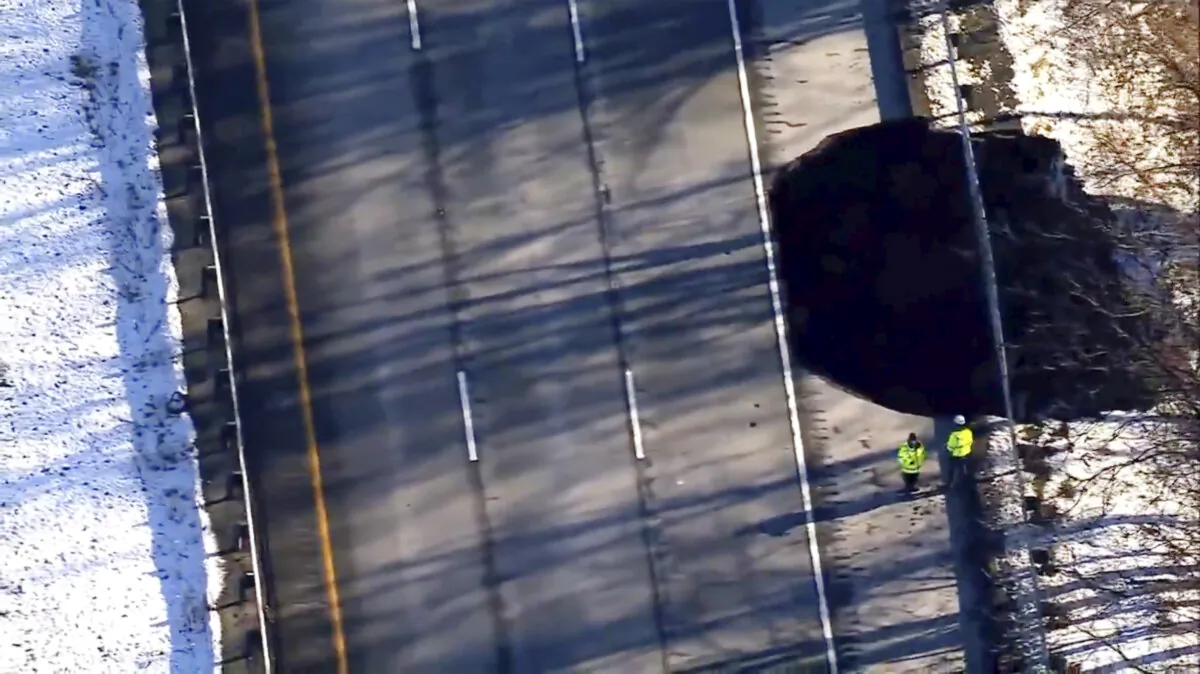 Work crews look on as a sinkhole opened up along Interstate 80 near Wharton, N.J. on Dec. 26, 2024. (WABC-TV via AP)