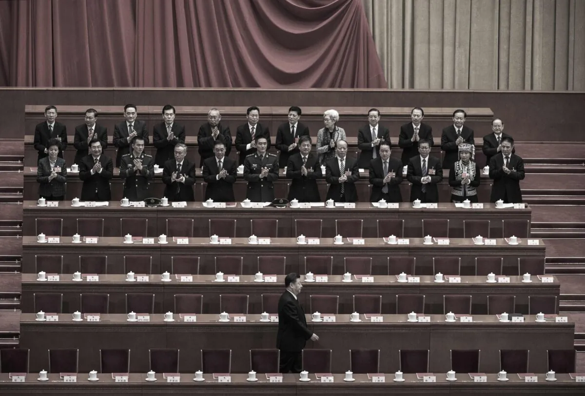 Xi Jinping, bottom, is applauded as he arrives to the closing session of the National People's Congress at The Great Hall Of The People in Beijing on March 20, 2018. (Kevin Frayer/Getty Images)