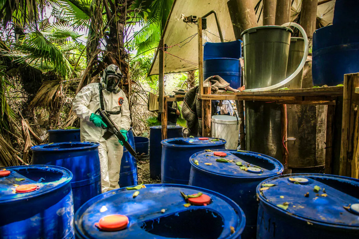 A Sinaloa state police officer helps dismantle of one of three clandestine laboratories that produces illicit synthetic drugs in El Dorado, Mexico, on June 4, 2019. (Rashide Frias/AFP via Getty Images)