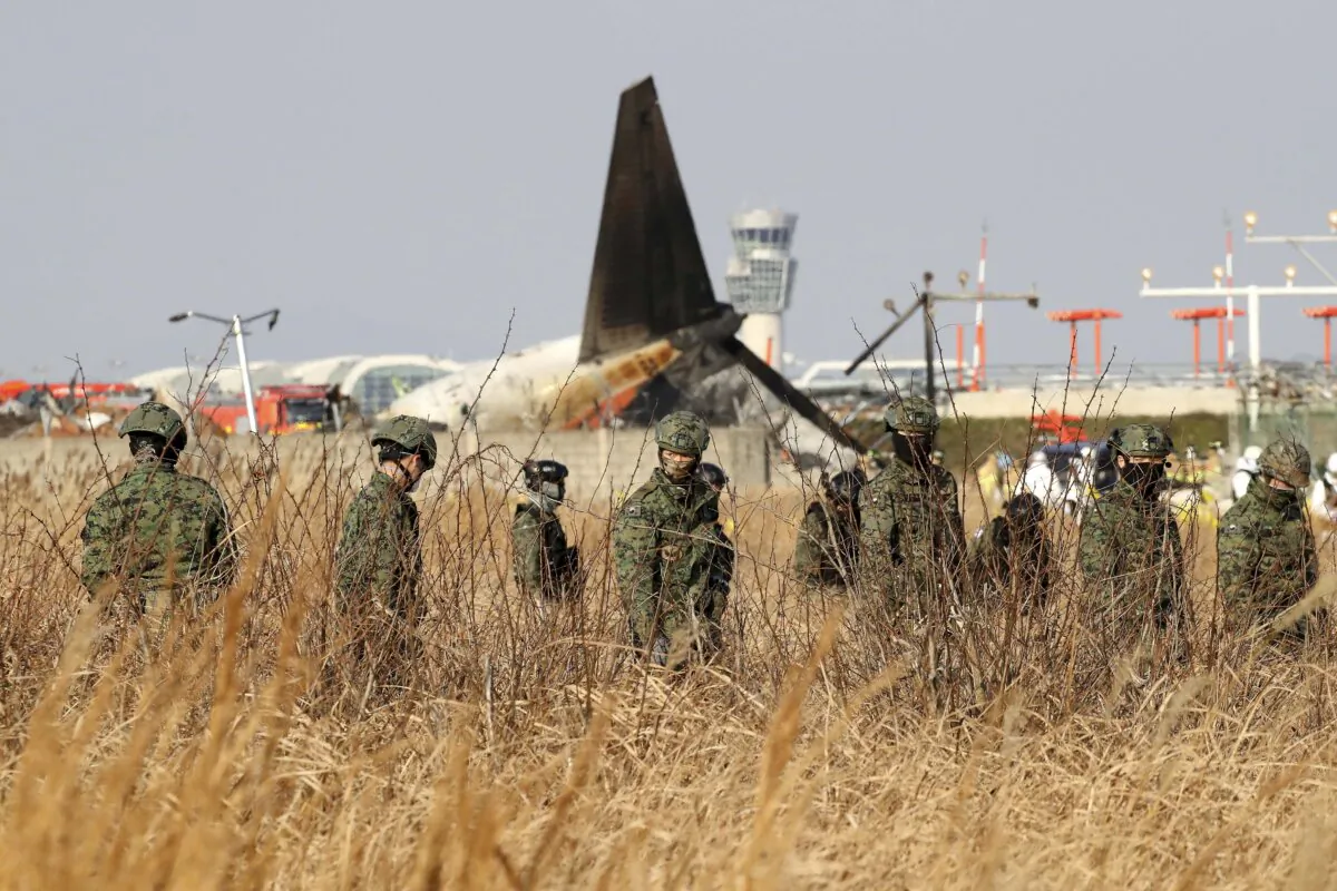South Korean soldiers work at the wreckage of a passenger plane at Muan International Airport in Muan-gun, South Korea, on Dec. 29, 2024. (Chung Sung-Jun/Getty Images)