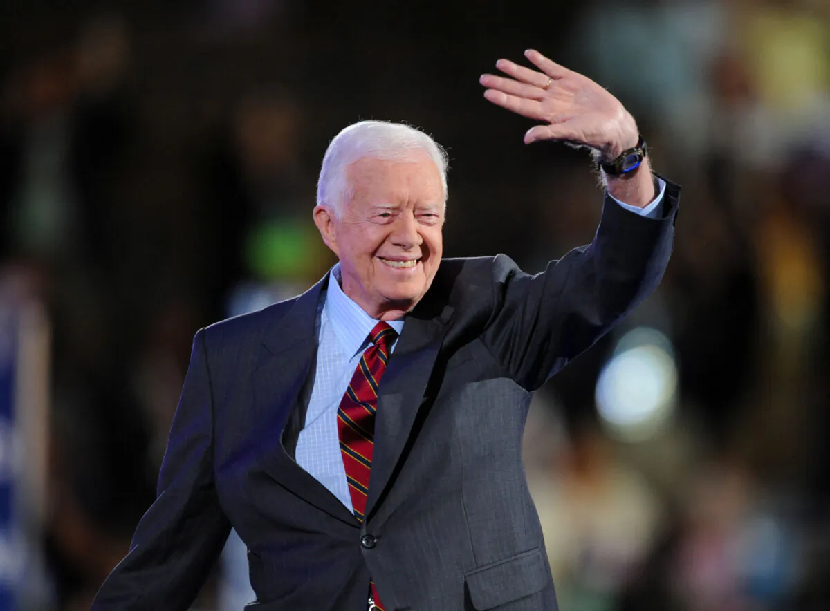 Former President Jimmy Carter waves to the crowd at the Democratic National Convention 2008 at the Pepsi Center in Denver, Colo., on Aug. 25, 2008. (Robyn Beck/AFP via Getty Images)