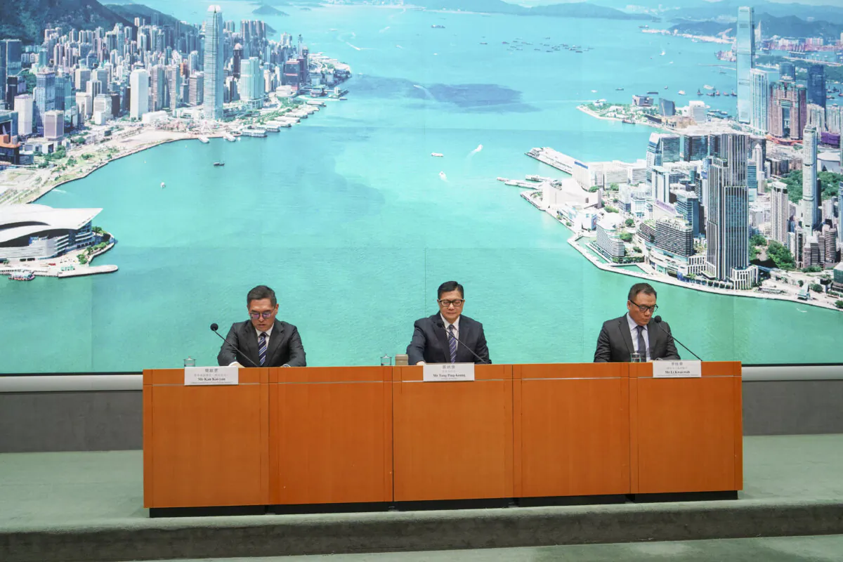 Chris Tang, the secretary for security of Hong Kong, announced that six people are wanted for arrest, at a press conference in Hong Kong on Dec. 24, 2024. (Adrian Yu/The Epoch Times)