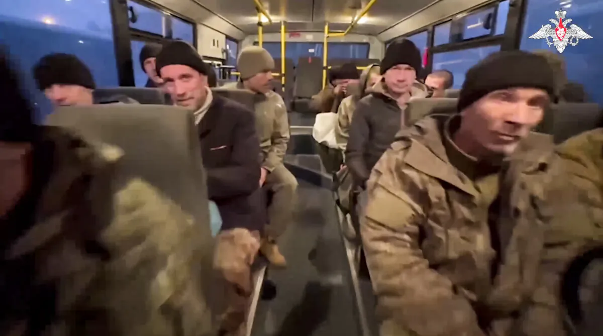 In this photo taken from video released by the Russian Defense Ministry Press Service on Dec. 30, 2024, a group of Russian soldiers sit in a bus after being released in a prisoners swap between Russia and Ukraine, at an unspecified location in Belarus. (Russian Defense Ministry Press Service via AP)