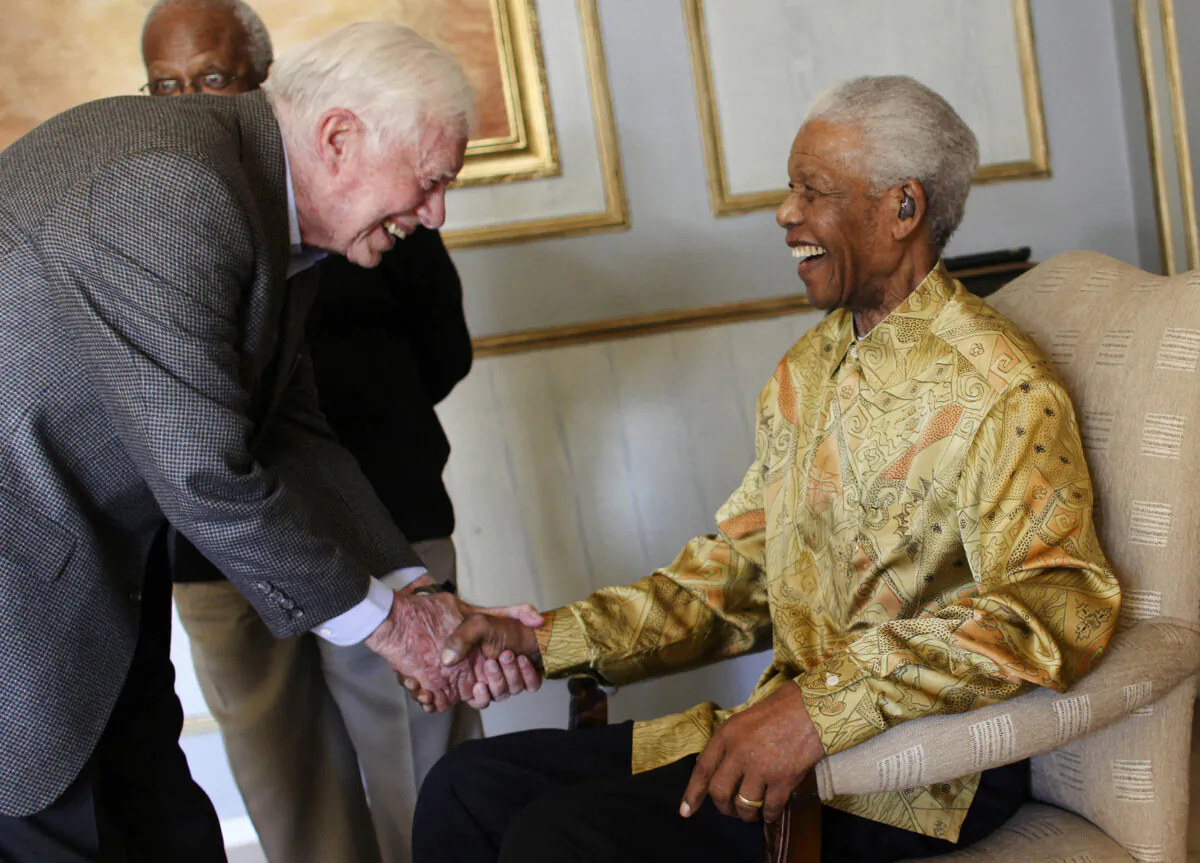 Nelson Mandela (R) is reunited with Jimmy Carter as other members of the Elders watch in Johannesburg, South Africa, on May 29, 2010. (Jeff Moore via Getty Images)