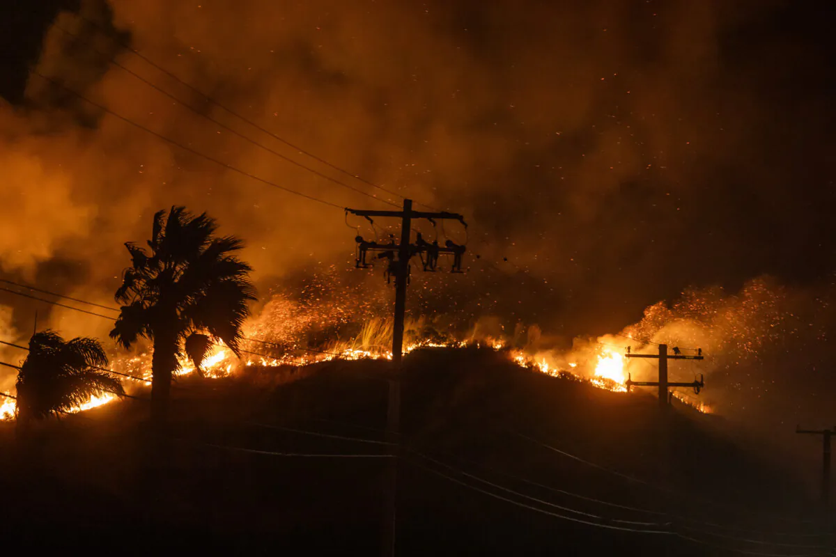 The Franklin Fire burns next to power lines at the Pacific Coast Highway near Malibu, Calif., on Dec. 11, 2024. (Apu Gomes/Getty Images)
