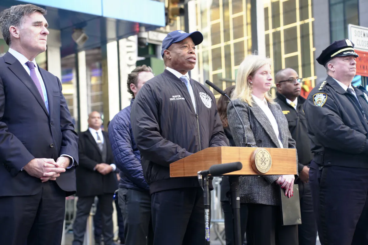NYC Mayor Eric Adams (C) and NYPD Commissioner Jessica Tisch (R) give a briefing on safety for the New Year ball drop in Times Square on Dec. 30, 2024. (Oliver Mantyk/The Epoch Times)