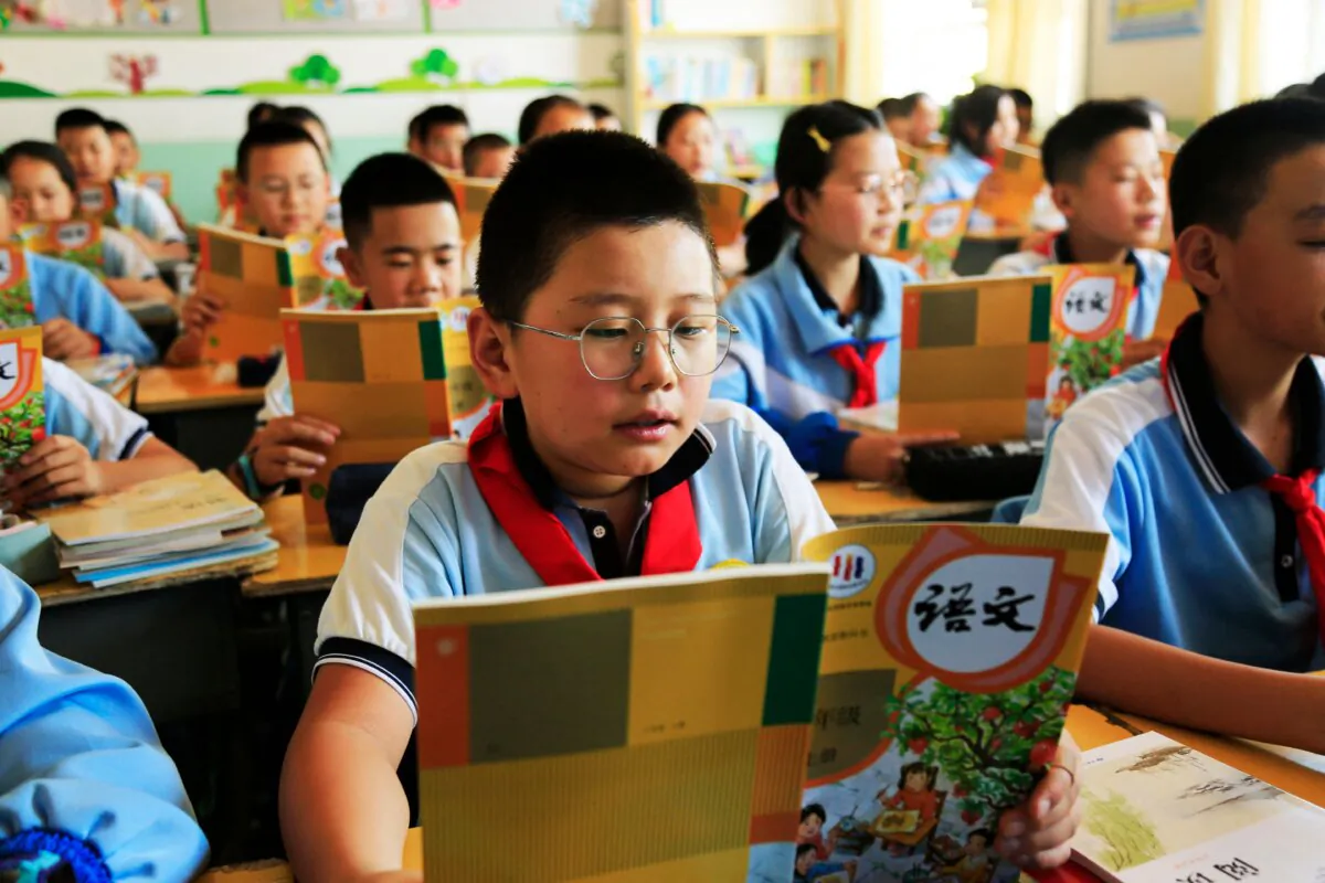 Students read from text books at a primary school in Zhangye city, in Gansu Province, China, on Aug. 28, 2023. (STR/AFP via Getty Images)