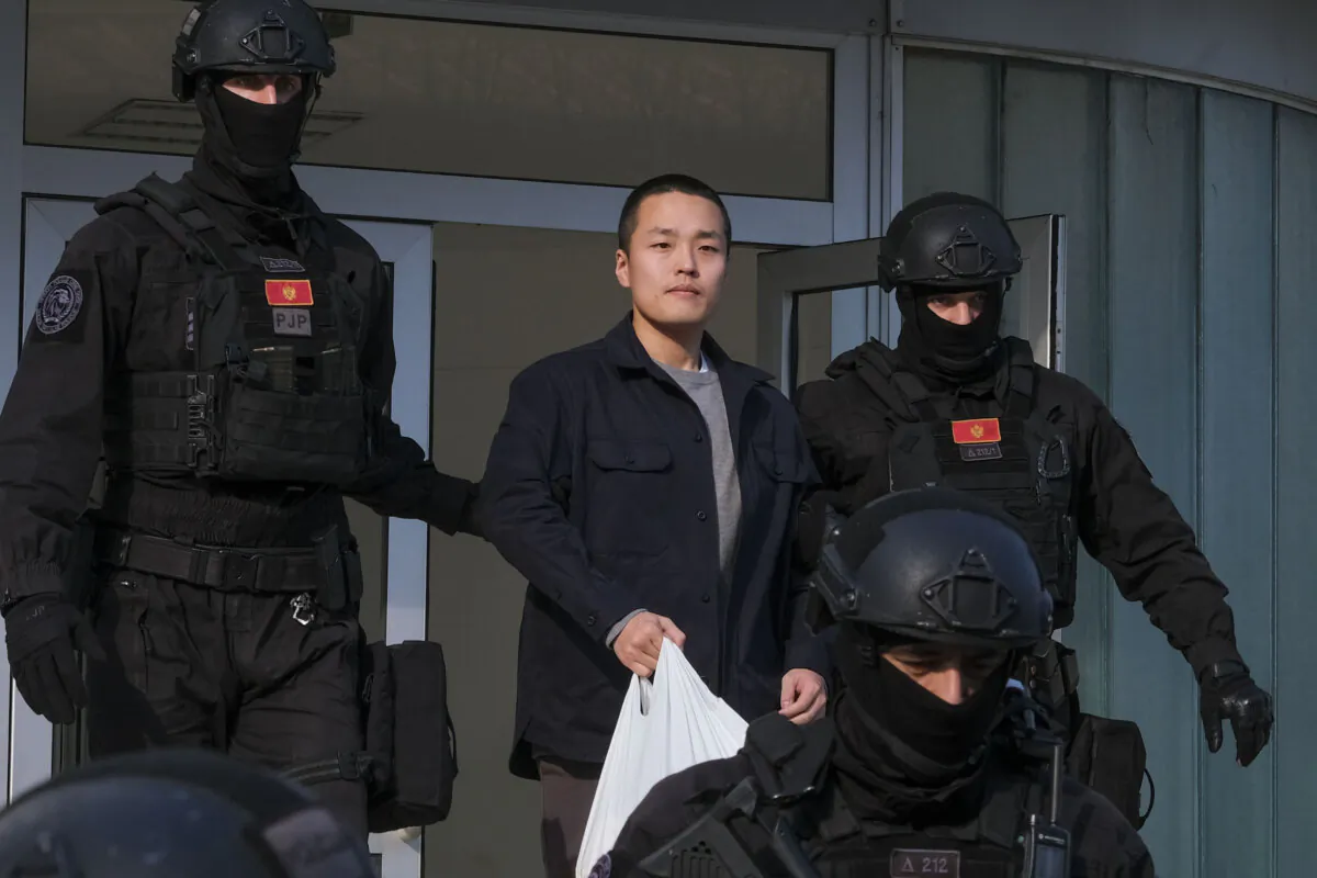 Montenegrin police officers escort Terraform Labs founder Do Kwon of South Korea in Montenegro's capital Podgorica on March 23, 2024.  (AP Photo/Risto Bozovic, File)