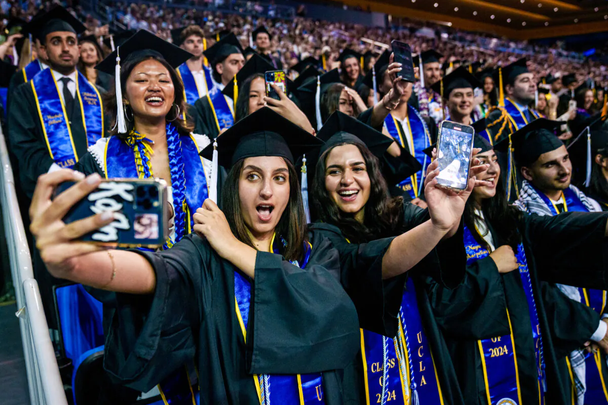 Graduating students take selfies during a UCLA graduation ceremony at the Pauley Pavilion in Los Angeles on June 14, 2024. (Eric Thayer/Getty Images)