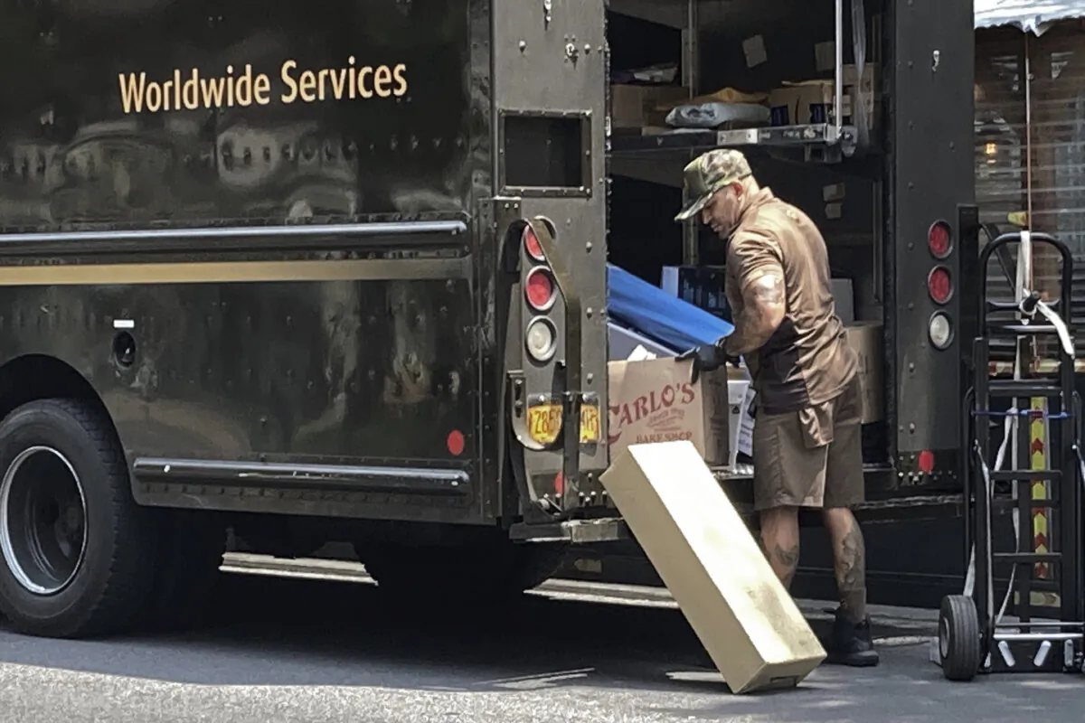 A United Parcel Service driver sorts his deliveries in Upper West Side in New York on July 15, 2023. (Richard Drew/AP Photo)