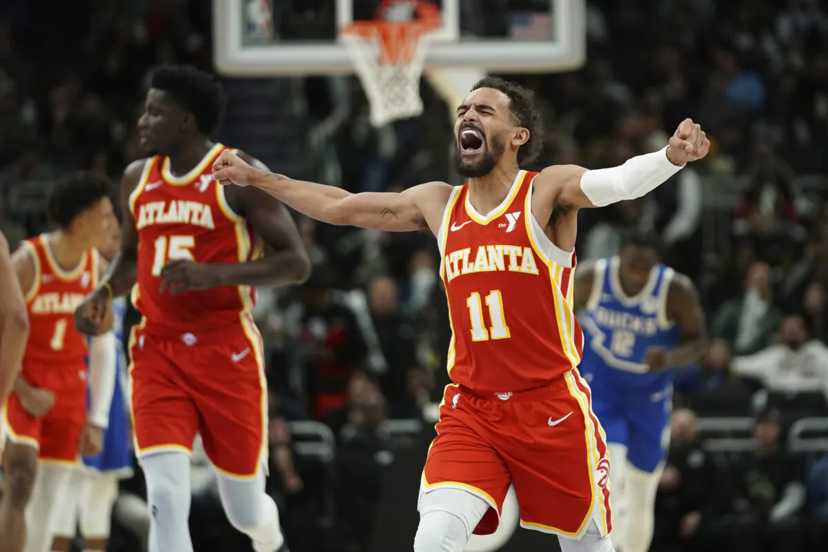 Atlanta Hawks' Trae Young (11) reacts as he walks to the bench during a timeout during the second half of an NBA basketball game against the Milwaukee Bucks, Wednesday, Dec. 4, 2024, in Milwaukee. (Aaron Gash/AP Photo)
